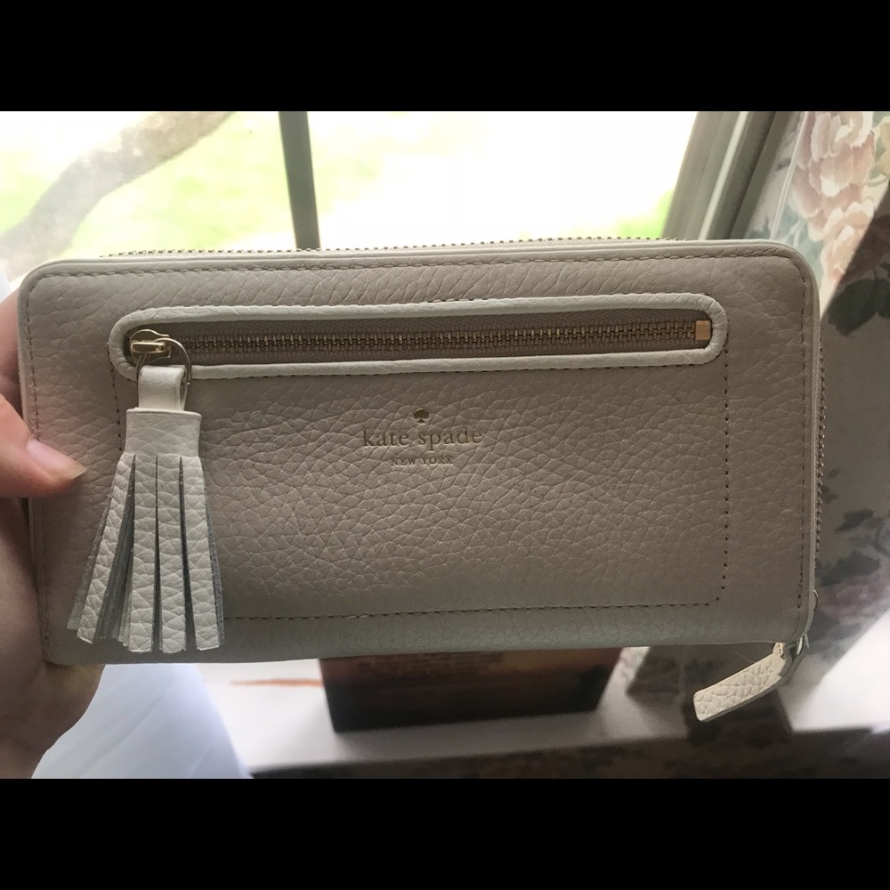 Tan/white Kate spade wallet with tassel